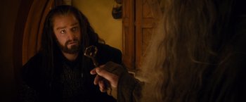 Movie still from “The Hobbit: An Unexpected Journey” (2012), directed by Peter Jackson – A man holding a wrench in front of another man; Close Up shot, Over the shoulder angle