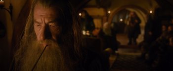 Movie still from “The Hobbit: An Unexpected Journey” (2012), directed by Peter Jackson – A woman with long hair is sitting in a dark room; Close Up shot, Over the shoulder angle