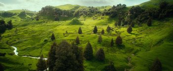 Movie still from “The Hobbit: An Unexpected Journey” (2012), directed by Peter Jackson – An aerial view of a lush green hillside; Extreme Wide shot, High angle