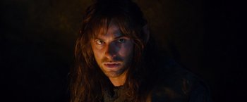 Movie still from “The Hobbit: An Unexpected Journey” (2012), directed by Peter Jackson – A person with long brown hair; Close Up shot, High angle