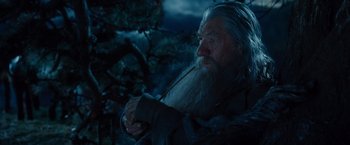 Movie still from “The Hobbit: An Unexpected Journey” (2012), directed by Peter Jackson – An old man with long white beard holding a pipe; Close Up shot, Low angle