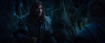 Movie still from “The Hobbit: An Unexpected Journey” (2012), directed by Peter Jackson – A person in a forest near a tree; Medium shot, Low angle