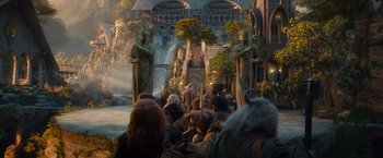 Movie still from “The Hobbit: An Unexpected Journey” (2012), directed by Peter Jackson – A crowd of people standing around a building; Wide shot, High angle