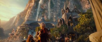 Movie still from “The Hobbit: An Unexpected Journey” (2012), directed by Peter Jackson – A group of people standing in front of a building; Extreme Wide shot, Low angle
