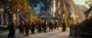 Movie still from “The Hobbit: An Unexpected Journey” (2012), directed by Peter Jackson – A group of people standing in front of a mountain; Wide shot, Low angle