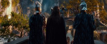 Movie still from “The Hobbit: An Unexpected Journey” (2012), directed by Peter Jackson – A group of people standing next to each other on a bridge; Wide shot, Low angle