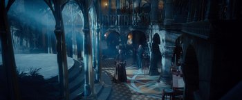 Movie still from “The Hobbit: An Unexpected Journey” (2012), directed by Peter Jackson – A group of people standing in a room with pillars; Extreme Wide shot, High angle