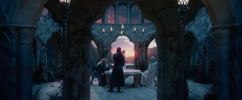 Movie still from “The Hobbit: An Unexpected Journey” (2012), directed by Peter Jackson – A group of people standing around a table; Wide shot, Low angle