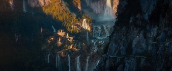 Movie still from “The Hobbit: An Unexpected Journey” (2012), directed by Peter Jackson – A view of a mountain with a lot of water coming out of it; Extreme Wide shot, High angle
