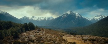 Movie still from “The Hobbit: An Unexpected Journey” (2012), directed by Peter Jackson – A group of people riding bikes on top of a hill; Extreme Wide shot, High angle