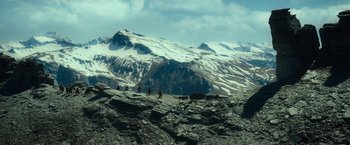 Movie still from “The Hobbit: An Unexpected Journey” (2012), directed by Peter Jackson – A group of people riding horses on top of a mountain; Extreme Wide shot, High angle