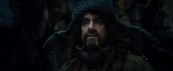 Movie still from “The Hobbit: An Unexpected Journey” (2012), directed by Peter Jackson – A person with a beard wearing a hat; Close Up shot, Low angle