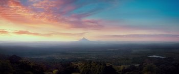 Movie still from “The Hobbit: An Unexpected Journey” (2012), directed by Peter Jackson – A view of a mountain from a distance at sunset; Extreme Wide shot, High angle