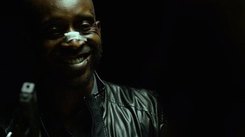 Movie still from “Daredevil” (2015), created by Drew Goddard – A man with a leather jacket smiling for the camera; Close Up shot, Low angle