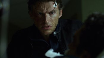 Movie still from “Daredevil” (2015), created by Drew Goddard – A person wearing a black jacket; Close Up shot, Over the shoulder angle