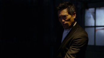 Movie still from “Daredevil” (2015), created by Drew Goddard – A man wearing a suit and a white shirt; Close Up shot, Over the shoulder angle