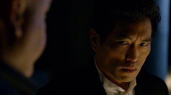 Movie still from “Daredevil” (2015), created by Drew Goddard – A person wearing a suit and tie; Close Up shot, Over the shoulder angle