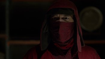 Movie still from “Daredevil” (2015), created by Drew Goddard – A man in a red robe and a black mask; Close Up shot, Over the shoulder angle