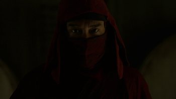 Movie still from “Daredevil” (2015), created by Drew Goddard – A man wearing a red hood and a red jacket; Close Up shot, Low angle
