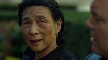 Movie still from “Daredevil” (2015), created by Drew Goddard – An older asian woman with long black hair; Close Up shot, Over the shoulder angle