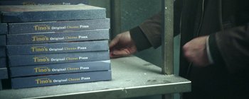 Movie still from “The House That Jack Built” (2018), directed by Lars von Trier – A stack of books on a shelf with a person reaching for the book; Extreme Close Up shot, High angle