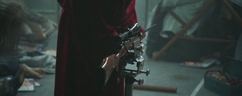 Movie still from “The House That Jack Built” (2018), directed by Lars von Trier – A person holding a gun in their hand; Extreme Close Up shot, High angle