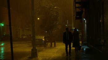 Movie still from “Daredevil” (2015), created by Drew Goddard – A man and a woman walking down a street in the rain; Extreme Wide shot, Low angle