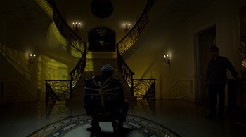 Movie still from “Daredevil” (2015), created by Drew Goddard – A man sitting in a chair in a room; Wide shot, Low angle