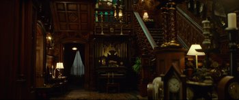 Movie still from “The House with a Clock in Its Walls” (2018), directed by Eli Roth – An organ in the middle of a living room; Wide shot, High angle