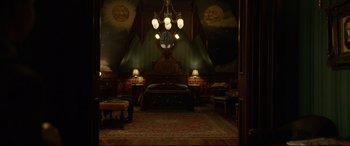 Movie still from “The House with a Clock in Its Walls” (2018), directed by Eli Roth – A bed room with a bed and two lamps on the ceiling; Extreme Wide shot, High angle