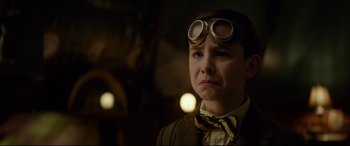 Movie still from “The House with a Clock in Its Walls” (2018), directed by Eli Roth – A young boy wearing goggles and a suit; Close Up shot, Low angle