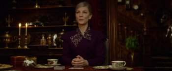 Movie still from “The House with a Clock in Its Walls” (2018), directed by Eli Roth – A woman sitting at a table with a cup of coffee; Medium shot, Over the shoulder angle