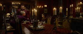 Movie still from “The House with a Clock in Its Walls” (2018), directed by Eli Roth – A man sitting at a dinner table with a woman; Medium shot, Over the shoulder angle