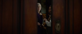Movie still from “The House with a Clock in Its Walls” (2018), directed by Eli Roth – A man and a woman standing next to each other in a room; Medium shot, Over the shoulder angle