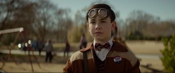 Movie still from “The House with a Clock in Its Walls” (2018), directed by Eli Roth – A young boy wearing a bow tie and goggles; Close Up shot, Over the shoulder angle