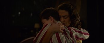 Movie still from “The House with a Clock in Its Walls” (2018), directed by Eli Roth – A woman holding a young boy who is hugging him; Medium shot, High angle