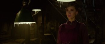 Movie still from “The House with a Clock in Its Walls” (2018), directed by Eli Roth – A woman standing in a dimly - lit room; Medium shot, Over the shoulder angle