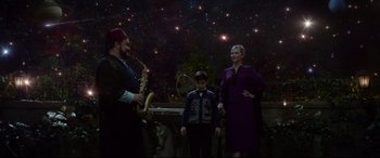 Movie still from “The House with a Clock in Its Walls” (2018), directed by Eli Roth – A man and a woman standing next to a young boy; Wide shot, High angle