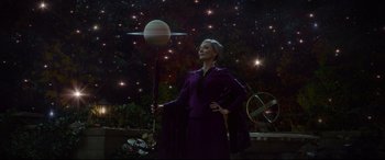 Movie still from “The House with a Clock in Its Walls” (2018), directed by Eli Roth – A woman standing in front of a space background; Wide shot, Low angle