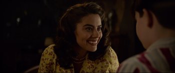 Movie still from “The House with a Clock in Its Walls” (2018), directed by Eli Roth – A woman with long brown hair smiles at the camera; Close Up shot, Over the shoulder angle