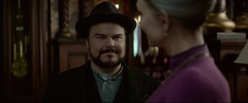 Movie still from “The House with a Clock in Its Walls” (2018), directed by Eli Roth – A man with a beard wearing a black hat; Close Up shot, Over the shoulder angle