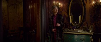 Movie still from “The House with a Clock in Its Walls” (2018), directed by Eli Roth – A woman standing in front of a mirror in a room; Medium shot, Over the shoulder angle