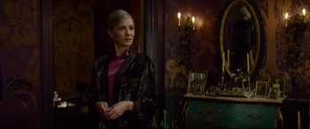 Movie still from “The House with a Clock in Its Walls” (2018), directed by Eli Roth – A woman standing in front of a mirror in a room; Medium shot, Over the shoulder angle