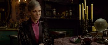 Movie still from “The House with a Clock in Its Walls” (2018), directed by Eli Roth – A woman sitting at a table in front of a counter; Close Up shot, Over the shoulder angle