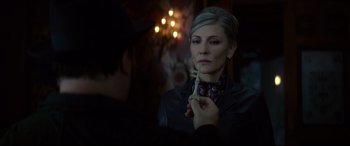 Movie still from “The House with a Clock in Its Walls” (2018), directed by Eli Roth – A woman in a black jacket is holding a green object; Close Up shot, Over the shoulder angle
