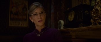 Movie still from “The House with a Clock in Its Walls” (2018), directed by Eli Roth – A woman wearing glasses and a purple sweater; Close Up shot, Over the shoulder angle