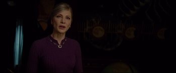 Movie still from “The House with a Clock in Its Walls” (2018), directed by Eli Roth – A woman standing in a dark room with a clock in the background; Medium shot, Over the shoulder angle