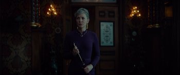 Movie still from “The House with a Clock in Its Walls” (2018), directed by Eli Roth – A woman in a purple dress holding a cane; Medium shot, Over the shoulder angle