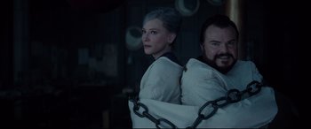 Movie still from “The House with a Clock in Its Walls” (2018), directed by Eli Roth – A woman and a man standing next to each other; Medium shot, Low angle