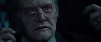 Movie still from “The House with a Clock in Its Walls” (2018), directed by Eli Roth – An old man wearing glasses and a white shirt; Close Up shot, Over the shoulder angle